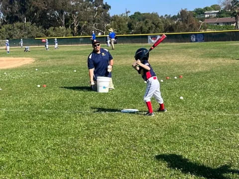 a kid swinging a baseball bat