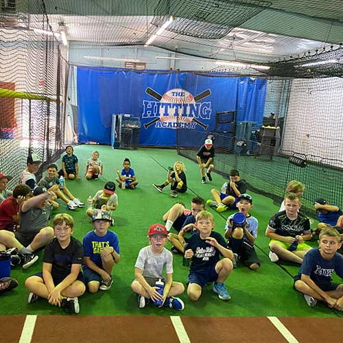 a group of people sitting on a field