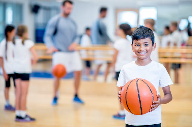 a boy holding a basketball