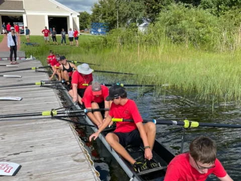 a group of people rowing a boat