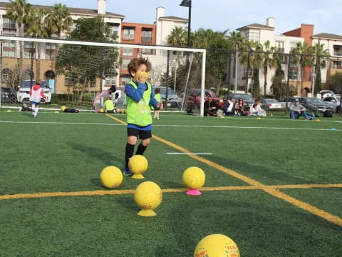 a little girl playing football
