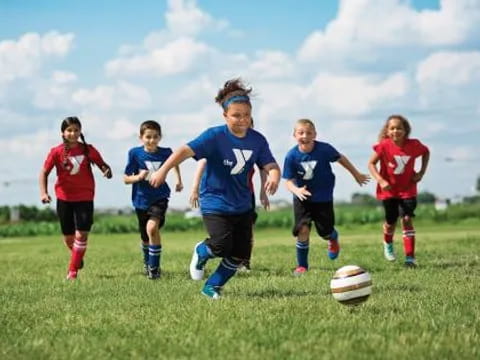 a group of kids playing football
