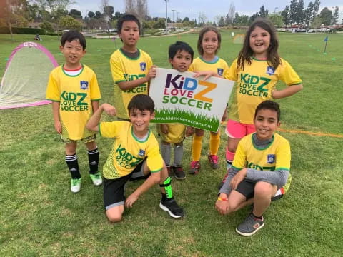 a group of kids holding a sign