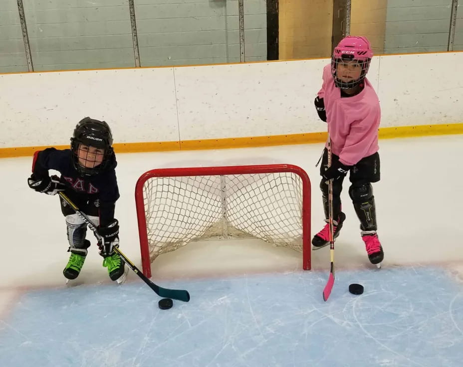 kids playing hockey on ice