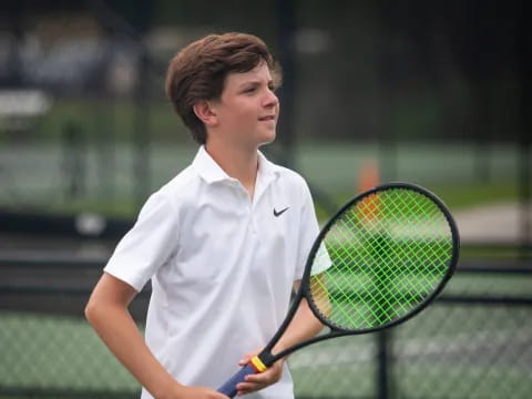 a man holding a tennis racket