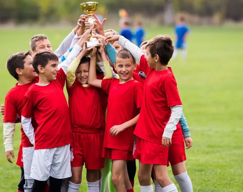 a group of boys in red uniforms