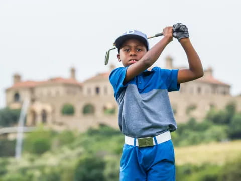 a boy holding a golf club