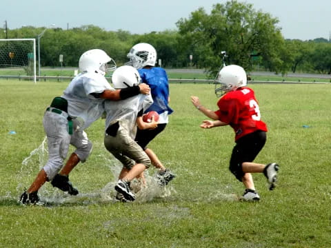 a group of kids playing football