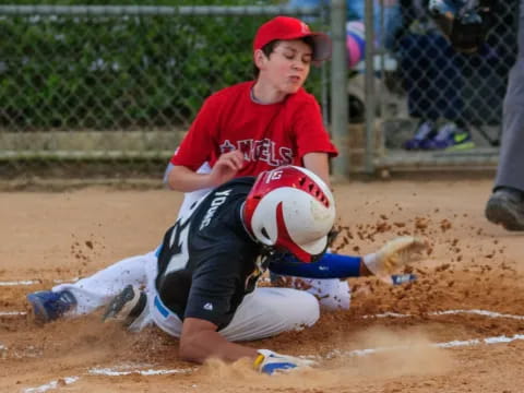a boy sliding into a base
