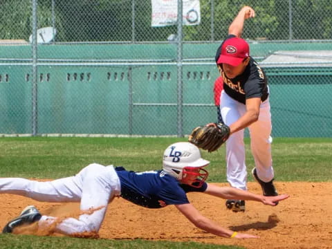 a kid sliding into a base