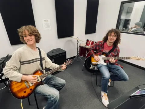 a couple of men playing guitars