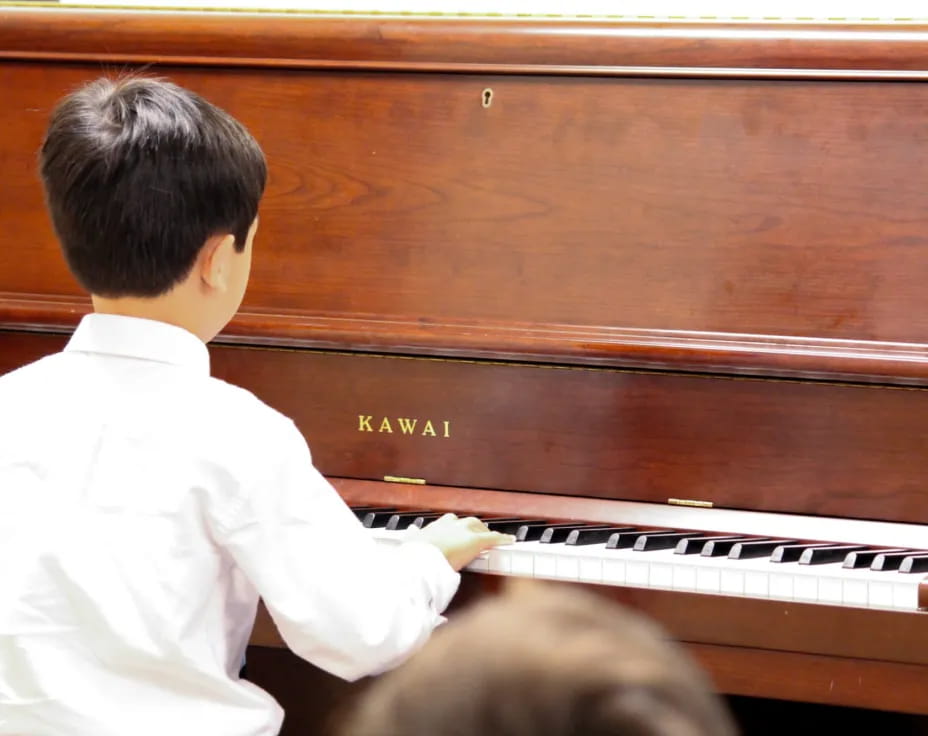 a boy playing a piano