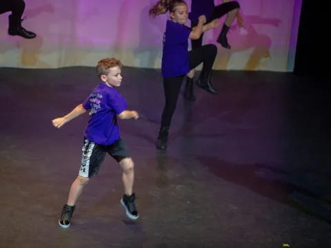 a boy running on a stage
