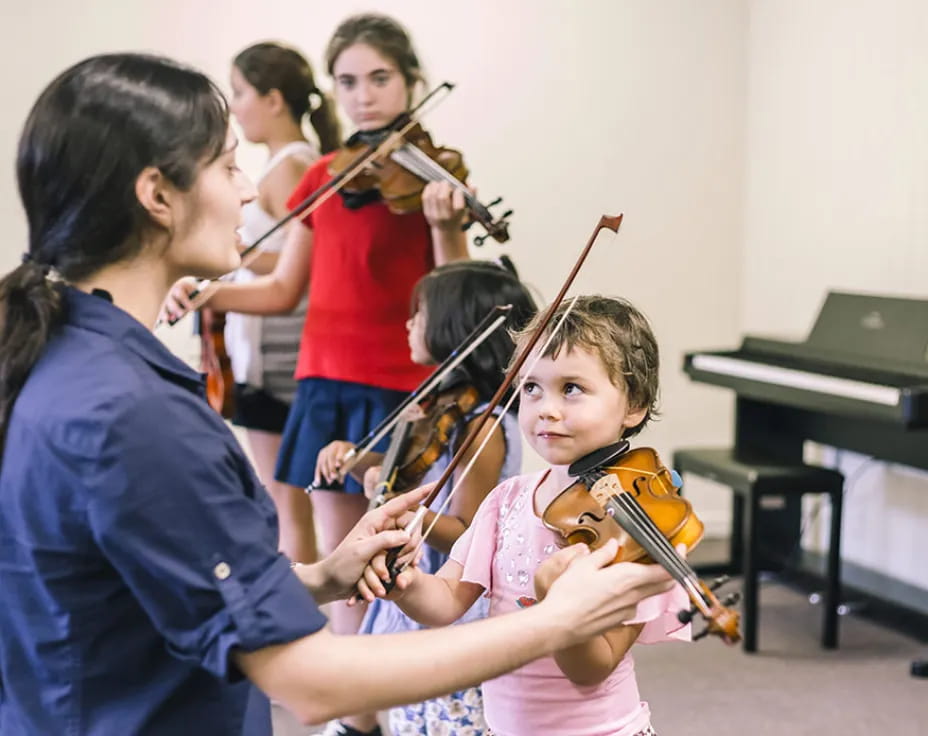 a group of people playing violin