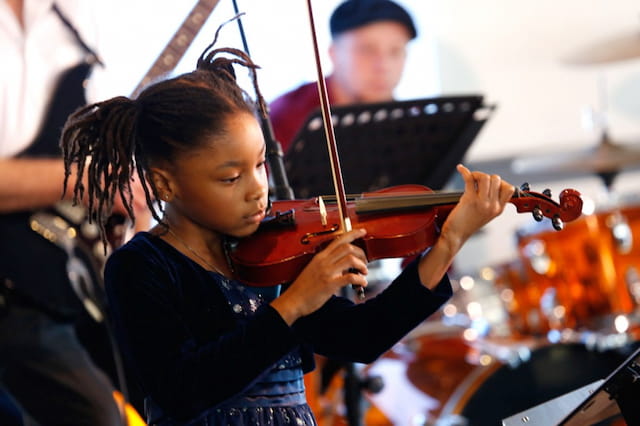 a girl playing a violin