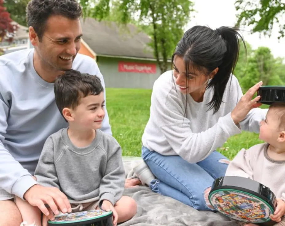a family sitting on a blanket
