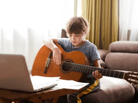 a boy playing a guitar