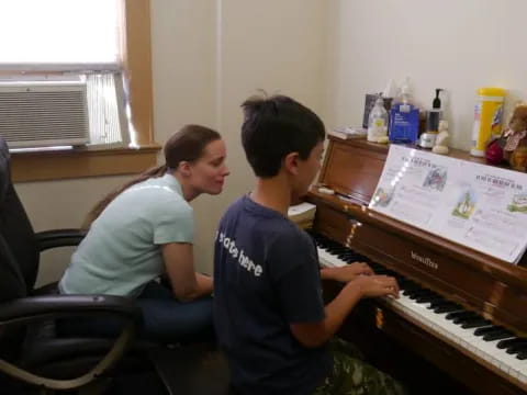 a man and a woman playing piano