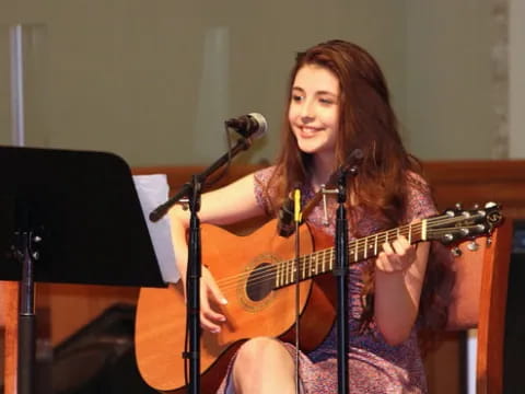 a woman playing a guitar