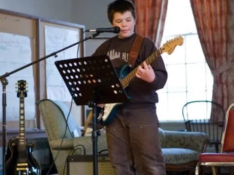 a boy playing a guitar