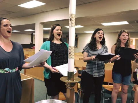 a group of women holding papers