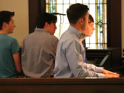 a group of men sitting at a desk