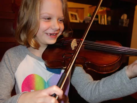 a girl playing a violin