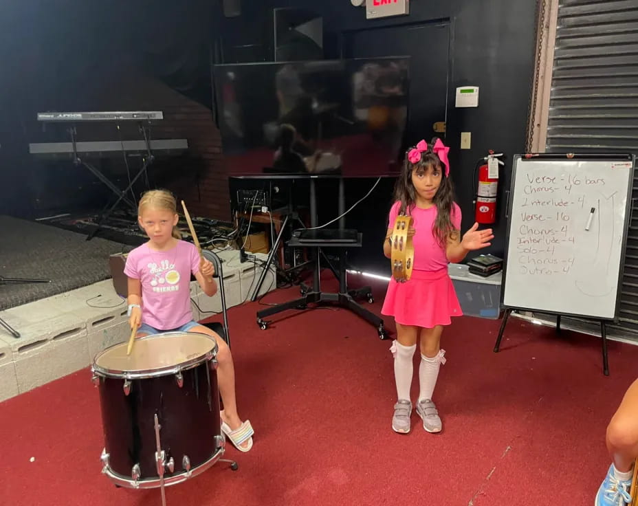a couple of girls playing drums