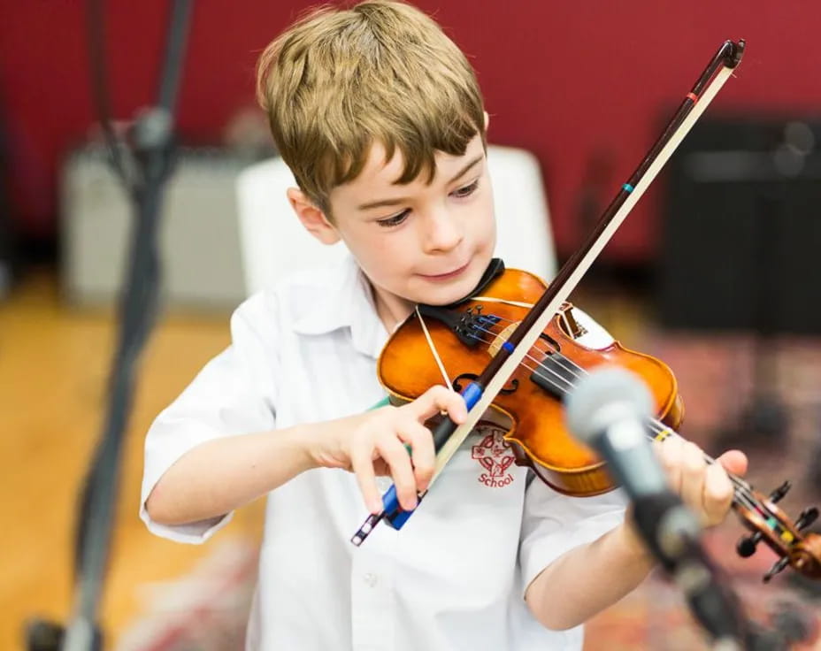a boy playing a violin