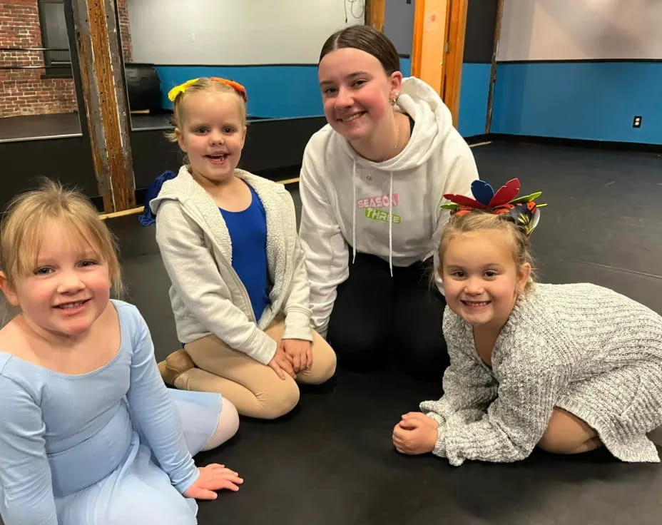 a group of children in white shirts