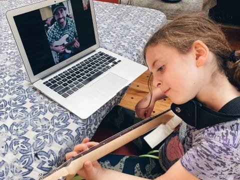 a young girl using a laptop