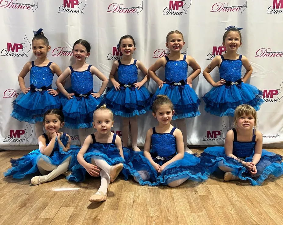 a group of girls in blue dresses