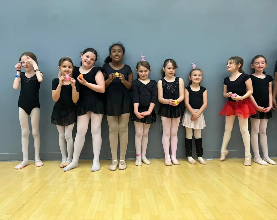 a group of girls in black dresses