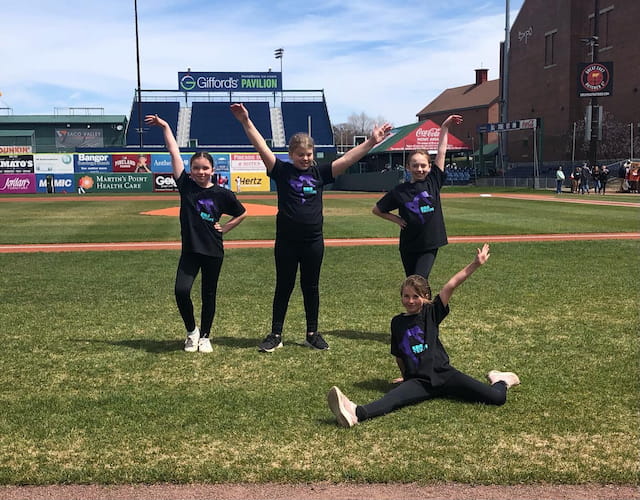 a group of people posing for a photo on a field