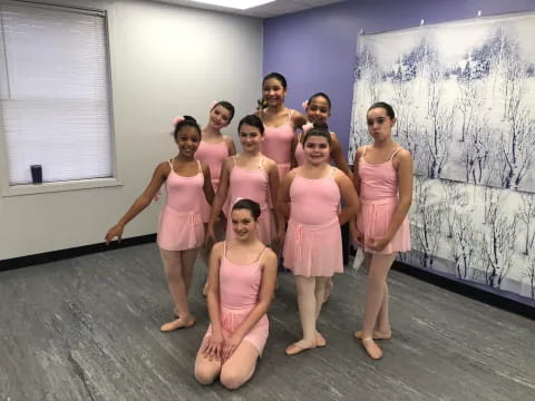 a group of women in pink dresses
