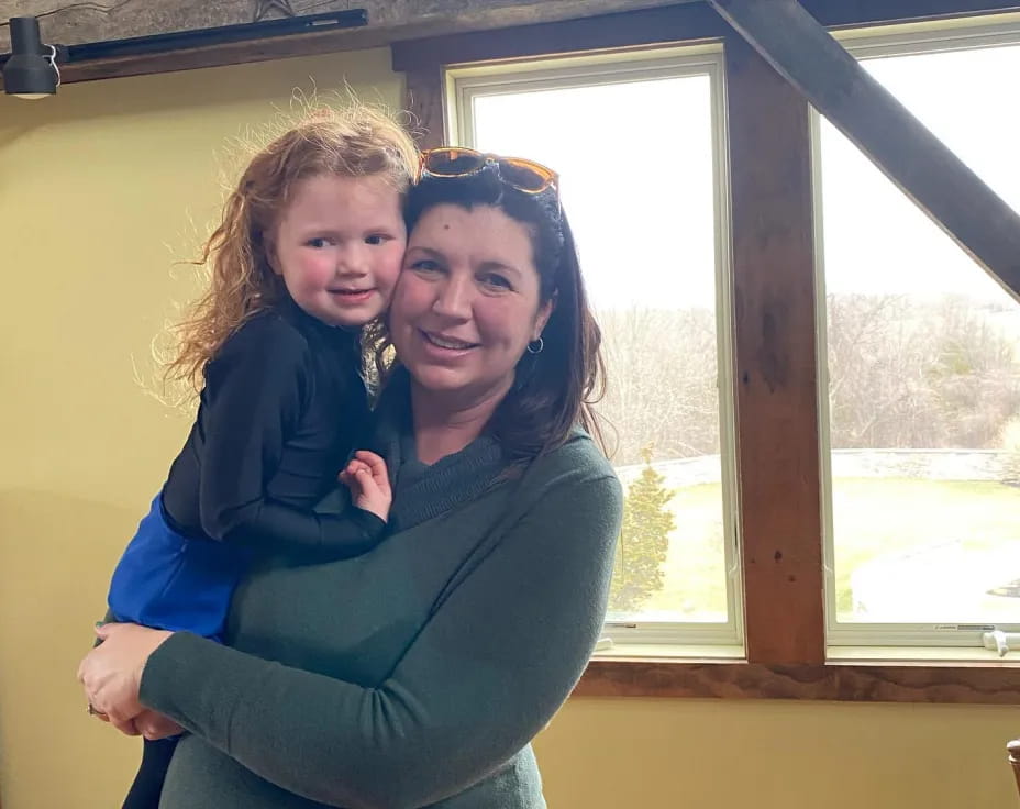 a person holding a child