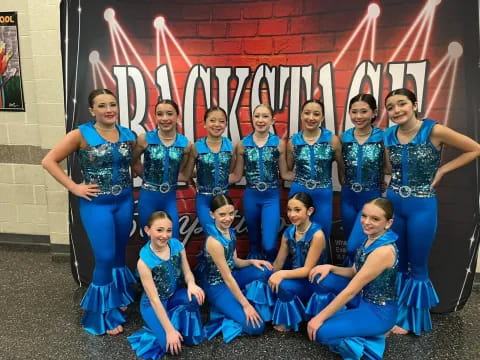 a group of women in blue dresses