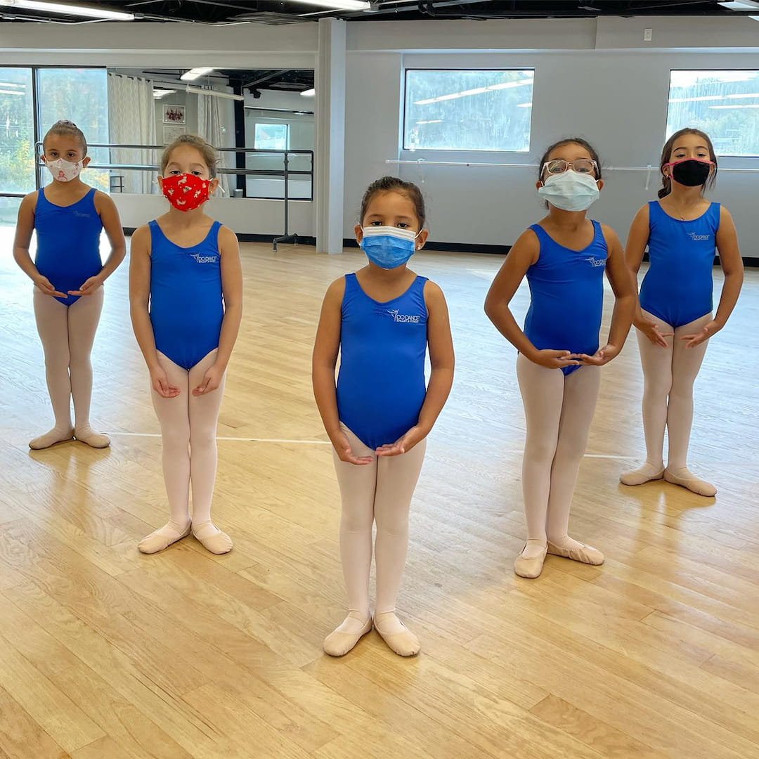 a group of women wearing blue scrubs and masks