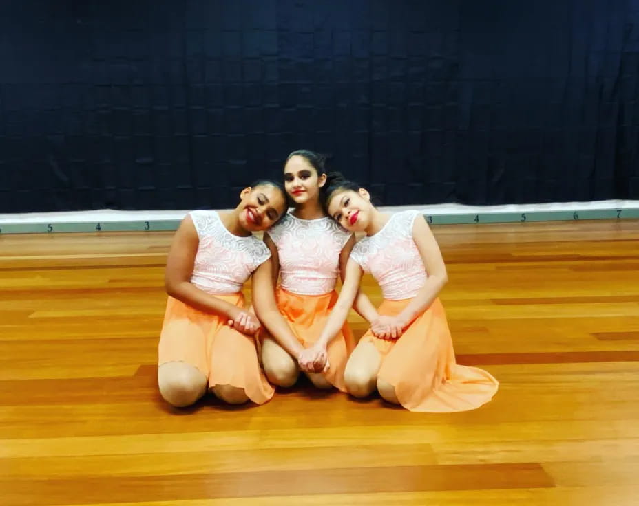 a group of women in white dresses