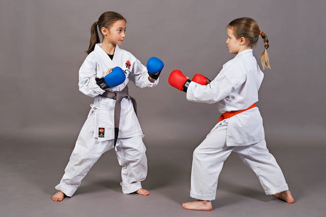two girls in karate uniforms