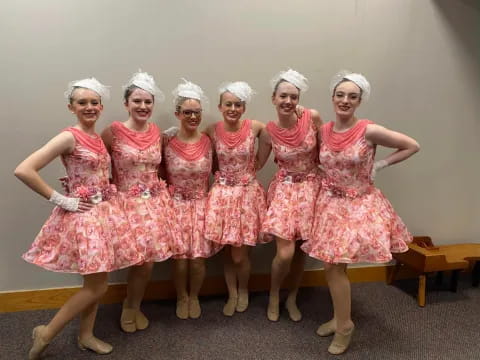 a group of women in dresses