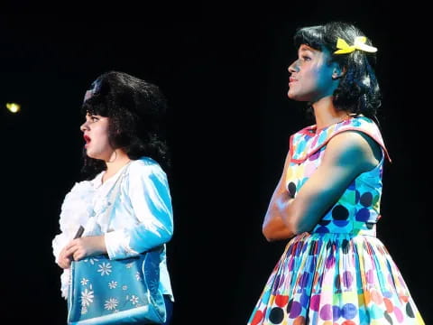 a couple of women in dresses