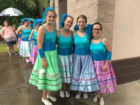 a group of women in dresses