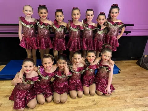 a group of girls in red dresses