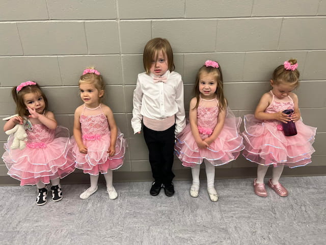 a group of girls in dresses