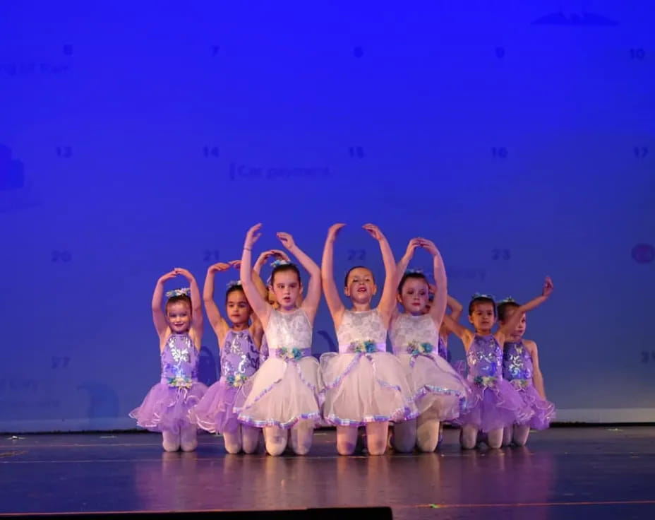a group of girls in white dresses