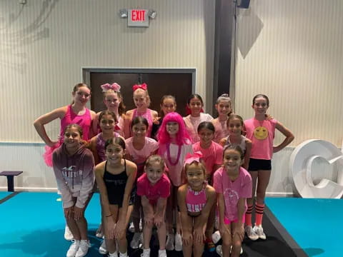 a group of women in pink shirts