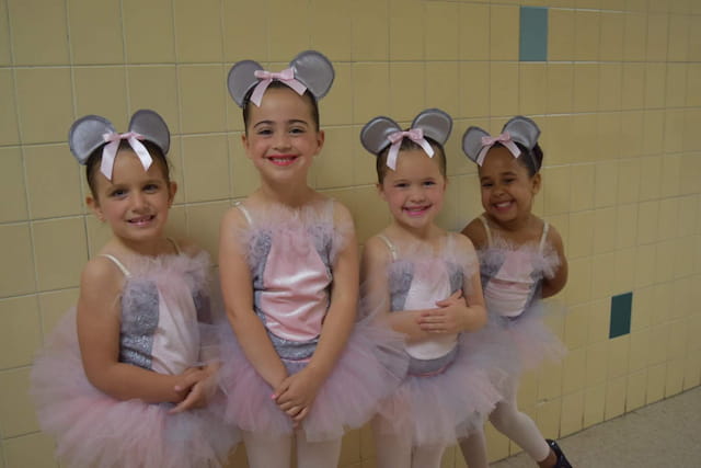a group of girls in white dresses