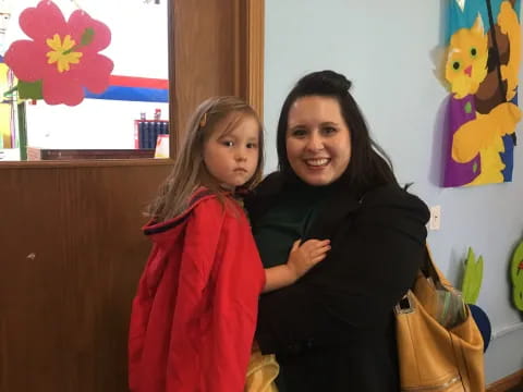 a person holding a child