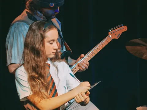 a couple of girls playing guitars